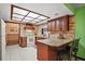 Updated kitchen featuring dark cabinets, tile floor, and granite counters at 10122 Canterbury Dr, Leesburg, FL 34788