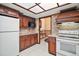 Kitchen with tile backsplash, granite counters, and white appliances at 10122 Canterbury Dr, Leesburg, FL 34788