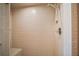 Tiled walk-in shower with a handheld shower head, perfect for easy cleaning and accessibility at 10122 Canterbury Dr, Leesburg, FL 34788