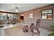 Sunroom with brick accents, multiple windows, tile flooring, and comfortable seating at 10122 Canterbury Dr, Leesburg, FL 34788