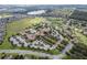 Aerial view of a residential community featuring a clubhouse, pool, and green spaces at 112 Flame Vine Way, Groveland, FL 34736