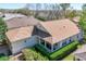 Aerial view of a single-Gathering home featuring a porch and manicured landscaping at 112 Flame Vine Way, Groveland, FL 34736