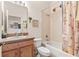 Full bathroom with combination tub and shower, vanity with sink and framed mirror at 112 Flame Vine Way, Groveland, FL 34736