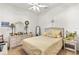 Cozy bedroom with a wicker bed frame, dresser, nightstand, and a ceiling fan at 112 Flame Vine Way, Groveland, FL 34736