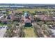 Aerial shot displays the community clubhouse and pool area, featuring a large pool, ample seating, and lush landscaping at 112 Flame Vine Way, Groveland, FL 34736