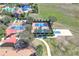 Aerial view of community courts featuring tennis, basketball, volleyball, and pickleball courts available to all residents at 112 Flame Vine Way, Groveland, FL 34736