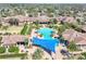 Aerial view of the community pool, set amongst beautiful landscaping and lounge chairs for residents to enjoy at 112 Flame Vine Way, Groveland, FL 34736
