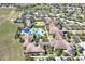 Aerial view of the community with swimming pool, community center, and tennis courts at 112 Flame Vine Way, Groveland, FL 34736