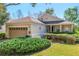 Charming single-story home featuring a two-car garage and well-maintained landscaping at 112 Flame Vine Way, Groveland, FL 34736