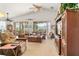 Open living room featuring vaulted ceilings, comfortable furnishings, and sliding glass doors to the sunroom at 112 Flame Vine Way, Groveland, FL 34736