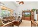 Open living room with natural light, comfortable seating, and view into the adjacent main bedroom at 112 Flame Vine Way, Groveland, FL 34736