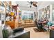 Cozy office space with natural light, a comfortable seating area, and ample decor at 112 Flame Vine Way, Groveland, FL 34736
