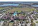 Aerial view of the community pool and clubhouse, with a large pool, palm trees, and plenty of seating at 112 Flame Vine Way, Groveland, FL 34736