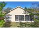 The back of a home reveals a screened-in porch ideal for outdoor living and relaxing at 112 Flame Vine Way, Groveland, FL 34736