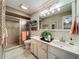 Stylish bathroom featuring a double sink vanity, walk-in shower, and decorative accents, offering a modern and comfortable space at 1131 Apple Ter, Leesburg, FL 34748