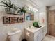Charming bathroom featuring a single sink vanity, decorative accents, and unique decor for a cozy, inviting feel at 1131 Apple Ter, Leesburg, FL 34748