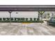 Convenient carport featuring clearly marked parking spaces and well-maintained landscaping at 1131 Apple Ter, Leesburg, FL 34748