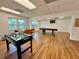 Bright game room featuring a foosball table, pool table, and lounge area at 1131 Apple Ter, Leesburg, FL 34748