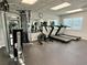 Brightly lit gym with weight machines, treadmills and floor to ceiling mirrors at 1131 Apple Ter, Leesburg, FL 34748