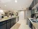 A kitchen boasting granite countertops, dark cabinetry with gold hardware and stainless steel appliances at 1131 Apple Ter, Leesburg, FL 34748