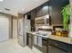 Well-equipped kitchen featuring granite counters, stainless steel appliances, and dark cabinets at 1131 Apple Ter, Leesburg, FL 34748