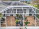 Aerial view of screened-in lanai, showcasing tile flooring and ample seating area at 1131 Apple Ter, Leesburg, FL 34748
