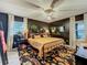 Stylish bedroom featuring dark accent wall, patterned rug, and stylish decor creating a cozy and sophisticated atmosphere at 1131 Apple Ter, Leesburg, FL 34748