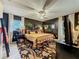 Modern bedroom featuring dark accent wall, patterned rug, and stylish decor creating a cozy and sophisticated atmosphere at 1131 Apple Ter, Leesburg, FL 34748