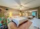Cozy main bedroom featuring soft lighting, plush pink rug, and a large mirrored closet, creating a serene retreat at 1131 Apple Ter, Leesburg, FL 34748