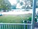 View of the large backyard featuring ample green space and a full perimeter fence for privacy at 11428 Pheasant Trl, Leesburg, FL 34788