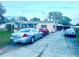 Long driveway leading to a single-story home and detached garage with ample parking at 11428 Pheasant Trl, Leesburg, FL 34788