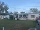 Inviting single-Gathering home boasting a covered porch and well-manicured lawn at 11428 Pheasant Trl, Leesburg, FL 34788