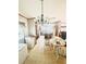 Eat-in kitchen with wood cabinets, a breakfast bar, and a charming chandelier above the dining table at 11428 Pheasant Trl, Leesburg, FL 34788