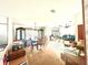 Spacious open-concept living and dining area with large windows and a chandelier fixture at 11428 Pheasant Trl, Leesburg, FL 34788