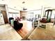 Cozy living room featuring a brick fireplace, hardwood floors, and an open layout at 11428 Pheasant Trl, Leesburg, FL 34788
