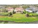An aerial view of the property with a large backyard, lake, and landscaped surroundings at 11579 Acosta Ave, Orlando, FL 32836