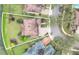 Aerial view of a home featuring a manicured lawn, a circular driveway, and mature landscaping at 11579 Acosta Ave, Orlando, FL 32836