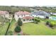 Aerial view of a home featuring a spacious backyard, lake view and lush landscaping at 11579 Acosta Ave, Orlando, FL 32836