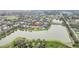 Aerial view showcasing a lakeside community with well-maintained homes and green spaces at 11579 Acosta Ave, Orlando, FL 32836