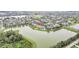Lovely aerial view of a lakeside community with well-maintained homes and lush landscaping at 11579 Acosta Ave, Orlando, FL 32836