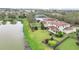 Aerial view showcasing a landscaped yard, and a tranquil lake at 11579 Acosta Ave, Orlando, FL 32836