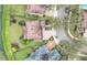Aerial view of a home featuring a manicured lawn, a circular driveway, and mature landscaping at 11579 Acosta Ave, Orlando, FL 32836