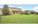 Expansive backyard features lush green lawn, covered patio, and manicured landscaping at 11579 Acosta Ave, Orlando, FL 32836