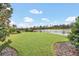 Beautiful backyard with a well-maintained lawn and scenic lake view at 11579 Acosta Ave, Orlando, FL 32836