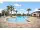 Inviting community pool area featuring palm trees, lounge chairs, and clear blue water at 11579 Acosta Ave, Orlando, FL 32836