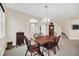 A dining room has a wooden table with seating for six and neutral walls at 11579 Acosta Ave, Orlando, FL 32836