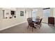 A dining room has a wooden table with seating for four and natural light at 11579 Acosta Ave, Orlando, FL 32836