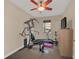 Home exercise room with ceiling fan, workout machine, treadmill and natural light at 11579 Acosta Ave, Orlando, FL 32836