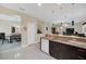 Modern kitchen with stainless steel appliances, granite countertops, and an adjacent dining area at 11579 Acosta Ave, Orlando, FL 32836