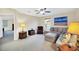 Bright living room with comfortable seating, artwork and a large window at 11579 Acosta Ave, Orlando, FL 32836